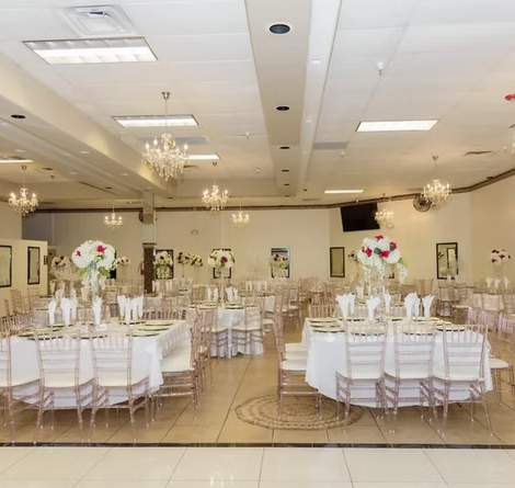 Banquet hall at Crown Event Center in Phoenix set with round tables, chandeliers and floral centerpieces